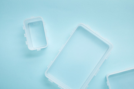 top view of empty lunch boxes isolated on blueの写真素材