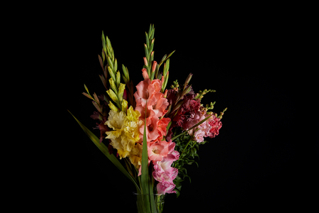 bouquet of beautiful pink, red, yellow and purple gladioli flowers isolated on black backgroundの写真素材
