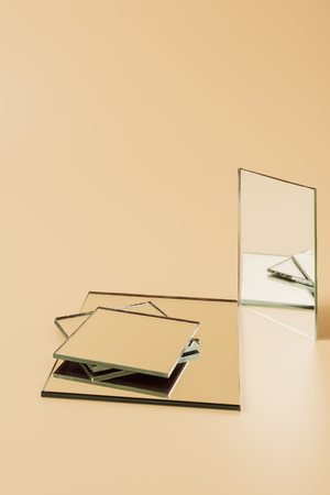 pile of small mirrors on beige tabletop