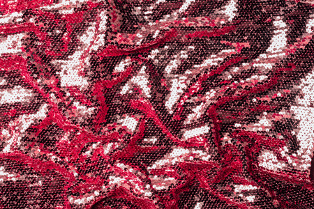 top view of burgundy textile with shiny sequins as backgroundの写真素材