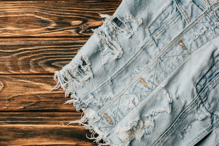 top view of light denim textile on wooden tableの写真素材