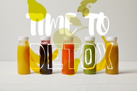 detox smoothies in bottles standing in row, refresh concept, time to detox inscriptionの写真素材