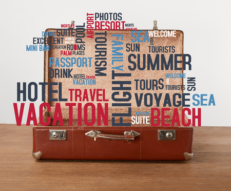 Open vintage suitcase with vacation icons and wordsの写真素材