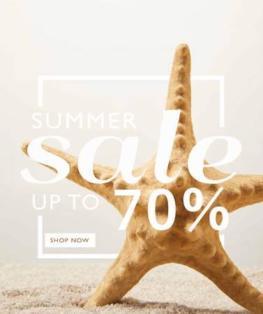 close up view of sea star on sand on grey background with summer sale discount