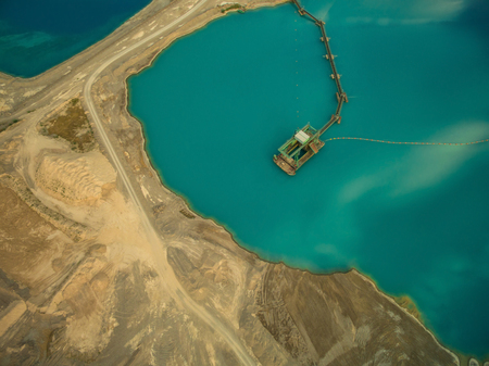aerial view of dredge replenish sand in blue lakeの写真素材