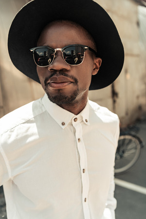 Handsome young african american man in hat and sunglassesの写真素材