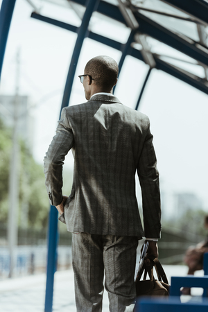 African american businessman wearing suit walking on train stationの写真素材