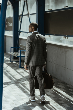 Confident businessman walking on public transport stationの写真素材
