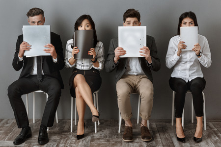 obscured view of multicultural business people with folders and notebooks waiting for job interview
