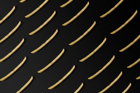 top view of french fries pattern isolated on blackの写真素材