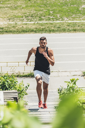 high angle view of young sportsman exercising on stairs at sport playgroundの写真素材