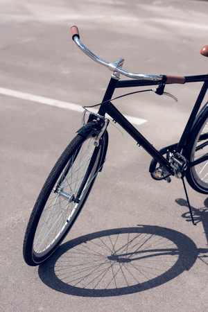 close up view of retro bicycle parked on streetの写真素材