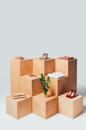 high angle view of high heels and twigs in vase on wooden stands, summer sale conceptの写真素材