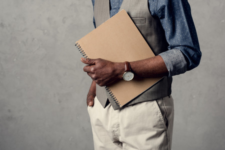 cropped view of african american businessman holding plannerの写真素材