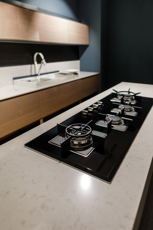 Stylish kitchen with with elegant shiny table and stoveの写真素材