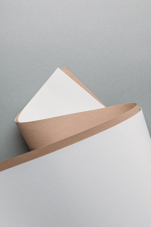 blank white and brown paper sheets on grey backgroundの写真素材