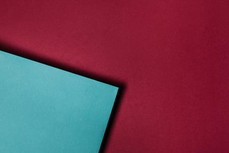 turquoise paper sheet on maroon backgroundの写真素材