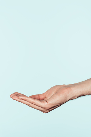 cropped shot of man gesturing by hand isolated on blue backgroundの写真素材