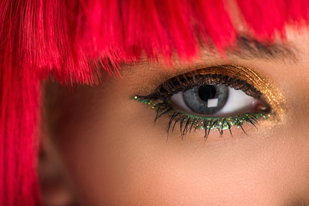 cropped image of attractive woman with red hair and makeup looking at cameraの写真素材