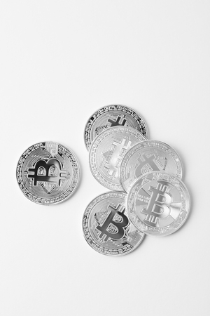 top view of pile of bitcoins on white surfaceの写真素材