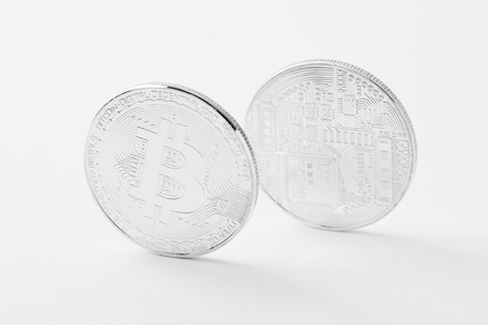 close-up shot of bitcoins on white surfaceの写真素材