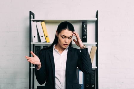 portrait of stressed businesswoman standing in office