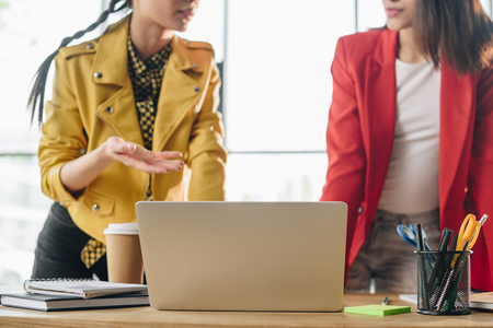 Diverse female business team working on project in light workspaceの写真素材
