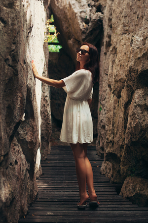 attractive woman touching cliffs at Ang Thong National Park, Ko Samui, Thailandの写真素材