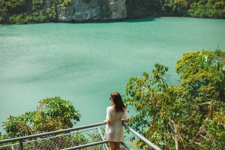 back view of woman looking at ocean bay at Ang Thong National Park, Ko Samui, Thailandの写真素材