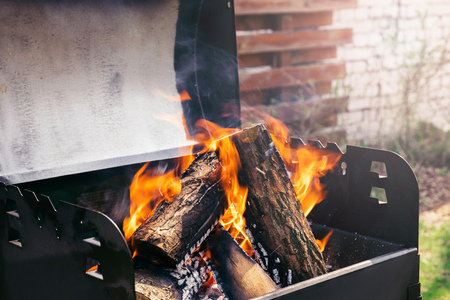Fire over wooden logs in outdoors bbqの写真素材