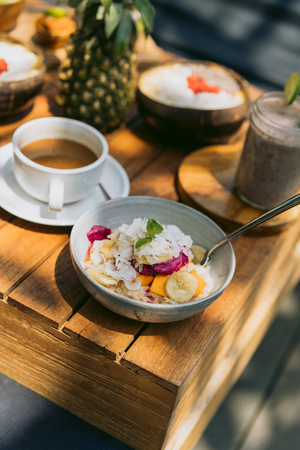 close-up view of delicious tropical dessert on wooden table outdoorsの写真素材