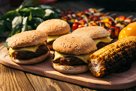 Hot delicious burgers and vegetables grilled for outdoors barbecueの写真素材