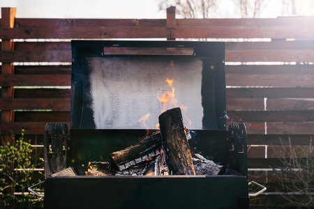 Logs burning in grill for barbecue outdoors