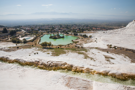 beautiful landscape with white rocks and pool in pamukkale, turkeyの写真素材