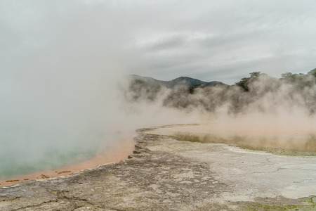 dramatic shot of steaming hot spring on cloudy day, New Zealandの写真素材