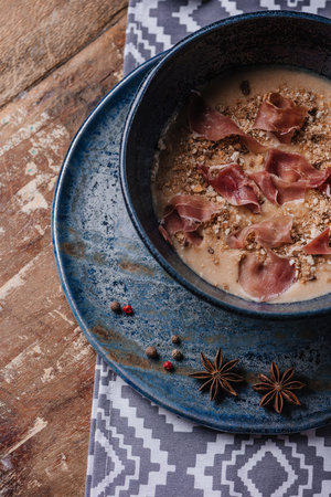 close-up view of fresh delicious cream soup with fried potatoes and jamonの写真素材