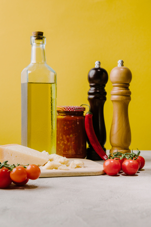 cherry tomatoes with cheese and spices for pasta on concrete tabletop, ingredients of italian cuisineの写真素材