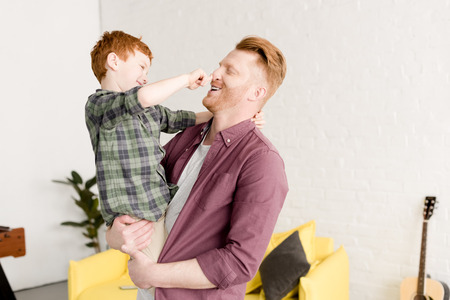 happy father and son having fun together at home