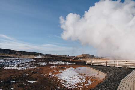 majestic view of wooden walkway and geothermal hot springs in iceland, Gunnuhver Hot Springs, reykjanesの写真素材