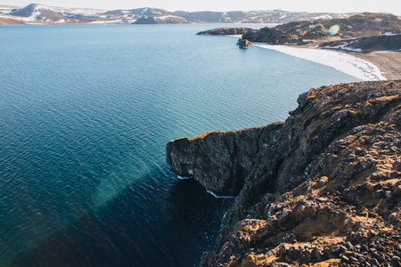 high angle view of beautiful icelandic sea coast with rocks and snow-covered mountains, Indjanahofdi, reykjanes, icelandの写真素材