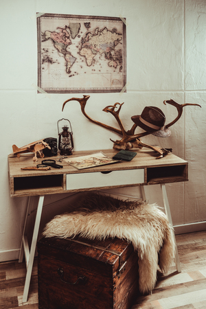 close up view of table with map, magnifying glasses and various decorationsの写真素材