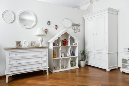 interior of modern light bedroom with white shelves and cupboardの写真素材
