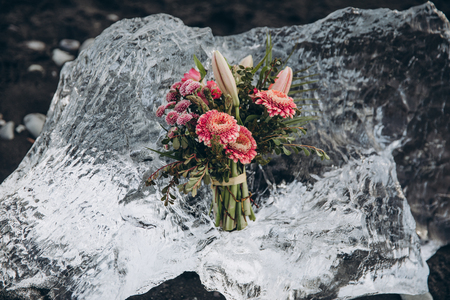 beautiful bouquet of flowers on clear transparent ice in icelandの写真素材