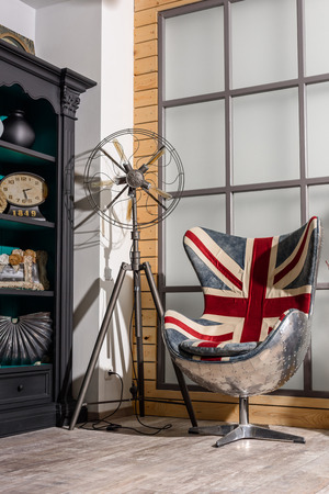 interior of modern retro styled living room with armchair with great britain flagの写真素材