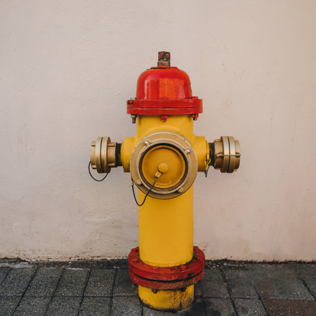 close-up view of red and yellow fire hydrant on street in reykjavik