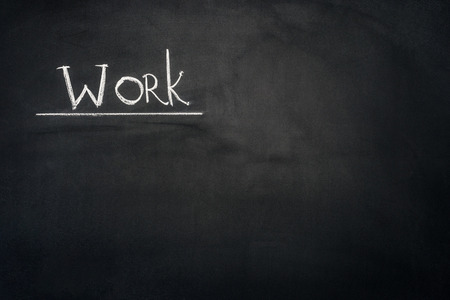 Work underlined inscription on dark chalkboard