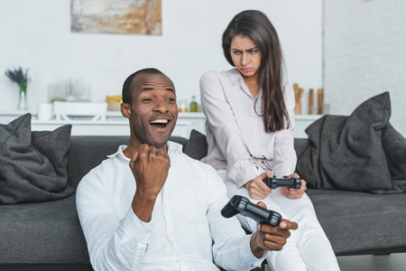 african american boyfriend winning video game at homeの写真素材