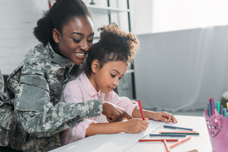 Mother soldier and african american child drawing togetherの写真素材