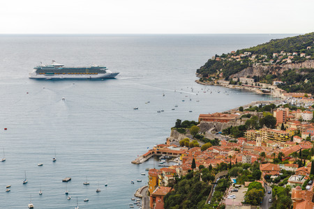 EZE, FRANCE - 17 SEPTEMBER 2017:  ocean liner near harbour of old european city located on seashore, Eze, Franceのeditorial素材