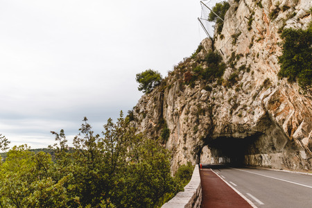 mountain road with tunnel on cloudy day, Cannes, Franceの写真素材